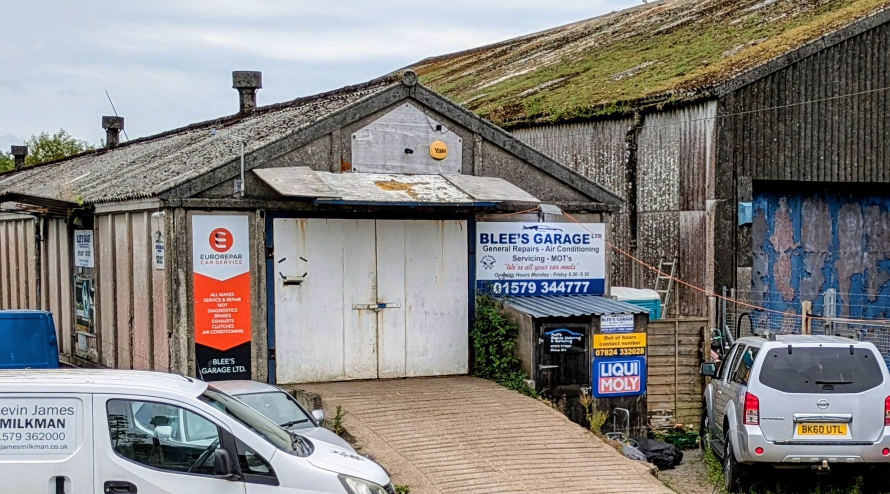 The front of the workshop: the Blee's Garage sign, the Eurorepar banner and the out of hours sign